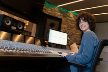 Young Woman Working In A Music Studio And Smiling At The Camera