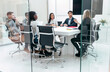 © nenetus - Business people discussing together in conference room during meeting at office in a modern startup.