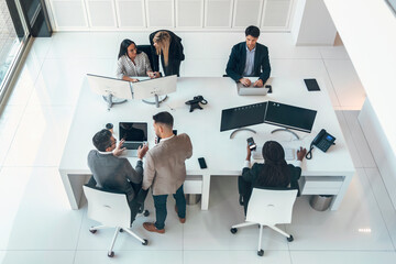 Wall Mural - Multiaging businesspeople working with computers in a modern startup.