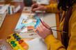 © YKD - Young woman working on watercolor painting of cityscape