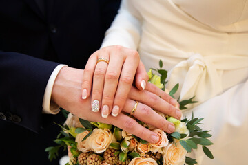 Wall Mural - A pair of gold rings for wedding ceremony on bride and groom hands