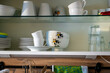 Plates and cups in a kitchen cupboard