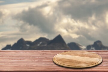 Poster - Empty wooden table with Mountain soft blurry background. Use as products display montage.