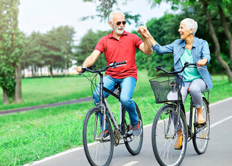 Poster - senior couple happy elderly love together retirement bicycle bike man woman mature fun