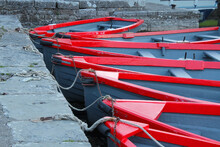 A Row Red And Grey Boats Tied Up At The Quayside