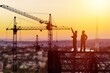 Silhouette of Engineer and worker on building construction site at sunset in evening time.