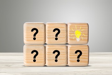 Question mark and light bulb on wooden blocks. Ideas, question mark ideas.