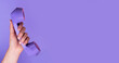 © valiantsin - Hand with retro phone receiver picked up. Modern minimalistic monochrome purple banner with copy space. High quality photo