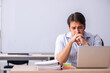© Elnur - Young male teacher in telestudying concept