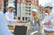 © zinkevych - Friendly young builder shaking hands with a pleased woman supervisor