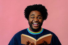 African American Man Smiling Posing With A Book In The Studio Over Pink Background