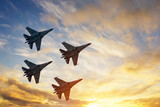 Four fighter jets in the shape of a diamond in the sky beautiful sunset.