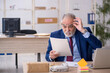 © Elnur - Old male employee working in the office