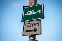 Low Angle View Of A Directional Sign, Pointing The Way Toward The Ferry Terminal In The Pacific Northwest