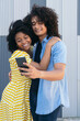 © ADDICTIVE STOCK - Loving ethnic girlfriend kissing boyfriend taking selfie on smartphone