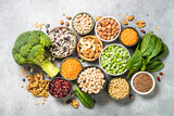 Fototapeta Mapy - Vegan protein source. Legumes, beans, lentils, nuts, broccoli, spinach and seeds. Top view on stone table. Healthy vegetarian food.