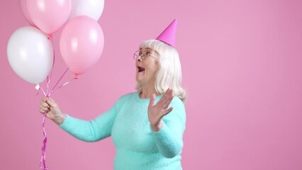 Poster - Old lady celebrate holiday hold air balls isolated pastel color background