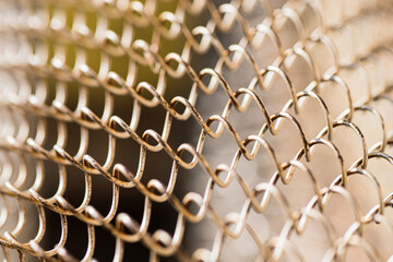Mesh rabitz , texture of weaving mesh network link. Close up of a fence. barrier on way. metal grid close-up. rusty mesh texture
