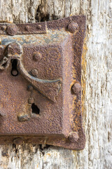 Wall Mural - Vertical shot of an old rusty lock on an old wooden door