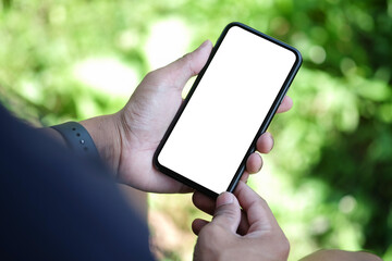 Wall Mural - young man using smart phone while sitting in the park. blank screen for advertisement.