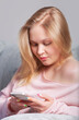 © Дворецкая Таня - Blonde girl with a smartphone in her hands