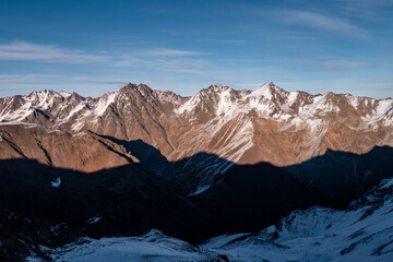 Wall Mural - Snowy Greater Caucasus ridge. Sunny day. Before suset. View from 3500m