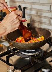 Sticker - Toss the red and yellow bell peppers in skillet to prepare the dish