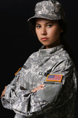 Wall Mural - African-American female soldier on dark background