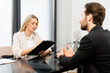 © Face Stock - Effective work in team. Concentrated managers are discussing something. Man giving advice to his thoughtful colleague
