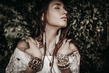 Young Hippie Woman With Closed Eyes And Many Beaded Bracelets