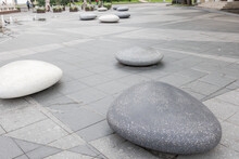 Large Gray Oval Stones Lie On The Square.