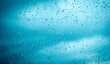 © arwiyada - Rain drops on glass water background or texture. Out of focus. rainy day abstract, blue nature wallpaper vintage, blurred lights view sky clouds outside window