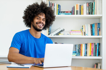 handsome african american software engineer at computer