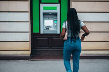 Young African American Woman Using A Atm Machine