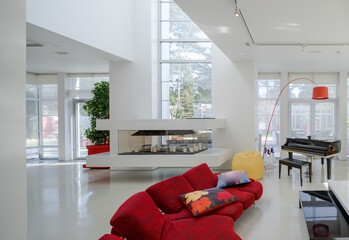 Modern interior. Luxury private house. Living room. Red sofa, piano