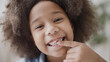 Smiling black girl showing missing tooth, dental care for children, tooth fairy