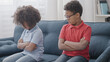 © Synthex - Offended kids sitting on couch, conflict between siblings, family relations