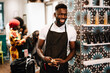 © Maskot - Cheerful male hairdresser looking away in barber shop