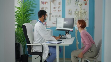 Wall Mural - woman patient at doctor's office on orthopedic consultation, coronavirus concept.