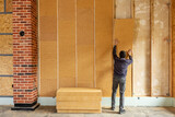 Fototapeta  - Installing thermal insulation inside a building, wood fiber boards 