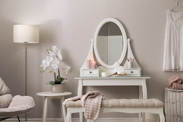 Canvas Print - Wooden dressing table with decorative elements and makeup products in room. Interior design