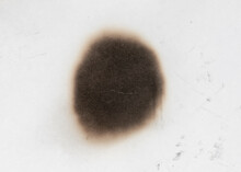 Paper Burn Black  Stain Isolated Over The White Background. Round Paper Burn Mark Close Up