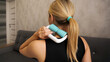 Woman massaging herself with body roller at home. Caucasian girl with a roller massager in her hand. Neck massage. Close-up. Prevention of neck pain
