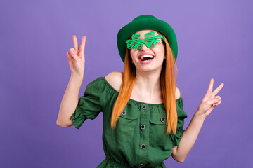 Wall Mural - Photo of funny excited woman dressed off-shoulders blouse st patrick headwear showing v-signs isolated violet color background