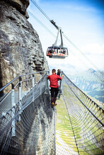 One Person Looking At The Cable Car From The Thrill Walk Cliff Pathway, Murren Birg, Jungfrau Region, Bern Canton, Switzerland