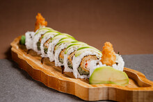 Sushi Freshly Prepared. Japanese Food, Sushi Roll Of Shrimp With Avocado In A Wooden Background. Fish And Crustaceans Slices. Front View With Copy Space.
