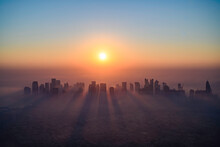 Doha Skyline At Sunrise With Morning Fog