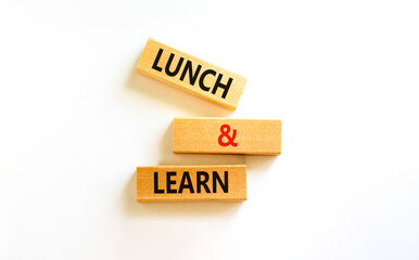 Poster - Lunch and learn symbol. Concept words Lunch and learn on wooden blocks. Beautiful white table white background. Copy space. Business, educational and lunch and learn concept.