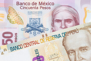 Wall Mural - A macro image of a pink, plastic fifty peso bank note from Mexico paired up with a beige, twenty sol bill from Peru.  Shot close up in macro.