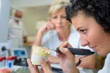 Female Dental Technician Working With Implant Mold